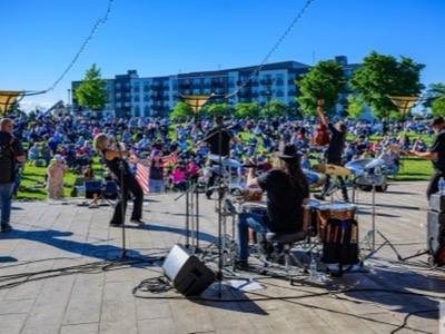 View from behind the band Mellencougar showing monitors and speaker setup at the Performance Pavilion, Heritage Park, Wheeling, Illinois