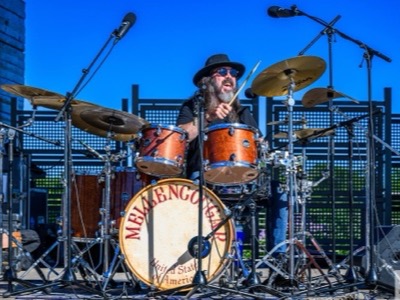 Mellencougar drummer performing with microphones and wedge monitor at the Performance Pavilion, Heritage Park, Wheeling, Illinois